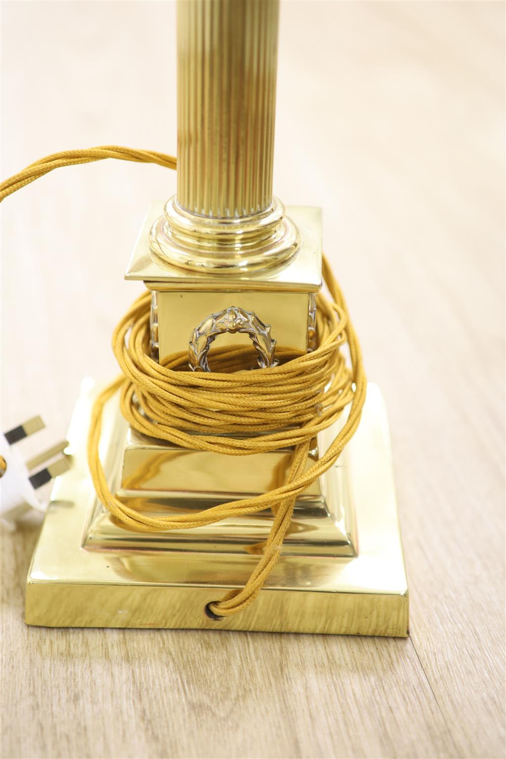 A brass Corinthian column table lamp and two others